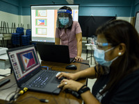 Teachers prepare online lectures for the opening of classes at a school in Valenzuela City in Metro Manila, Philippines on October 2, 2020....