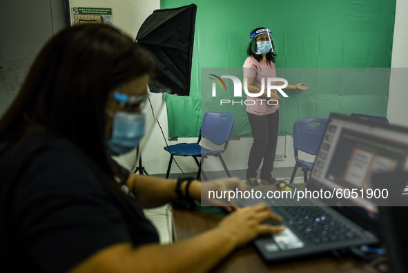 Teachers make use of green screen in filming lectures in preparation for the opening of classes at a school in Valenzuela City in Metro Mani...