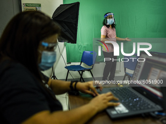 Teachers make use of green screen in filming lectures in preparation for the opening of classes at a school in Valenzuela City in Metro Mani...