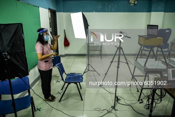 A teacher makes use of green screen in filming lectures in preparation for the opening of classes at a school in Valenzuela City in Metro Ma...