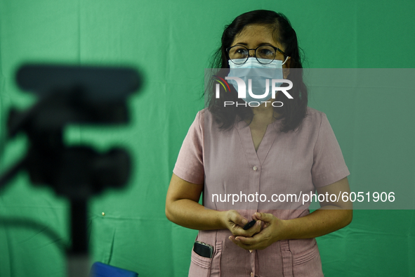 A teacher makes use of green screen in filming lectures in preparation for the opening of classes at a school in Valenzuela City in Metro Ma...