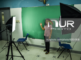 A teacher makes use of green screen in filming lectures in preparation for the opening of classes at a school in Valenzuela City in Metro Ma...