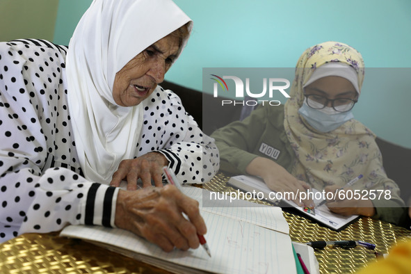 Palestinian teacher Ekram el-astal, 80, teaches her neighbours' students an Maths language lesson as schools are shut due to the coronavirus...