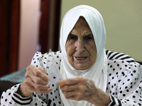 Palestinian teacher Ekram el-astal, 80, teaches her neighbours' students an Maths language lesson as schools are shut due to the coronavirus...