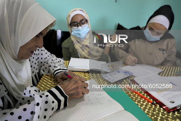 Palestinian teacher Ekram el-astal, 80, teaches her neighbours' students an Maths language lesson as schools are shut due to the coronavirus...