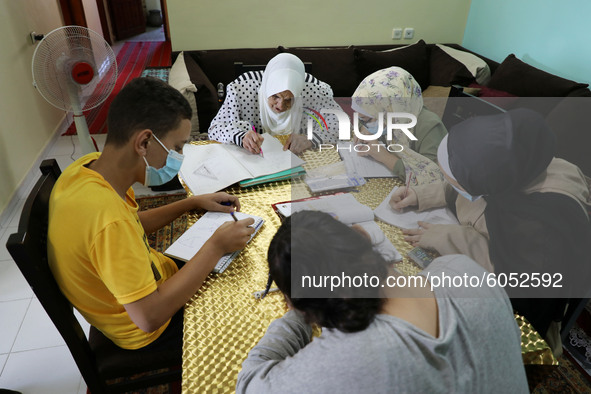 Palestinian teacher Ekram el-astal, 80, teaches her neighbours' students an Maths language lesson as schools are shut due to the coronavirus...