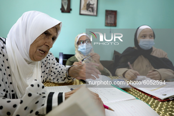 Palestinian teacher Ekram el-astal, 80, teaches her neighbours' students an Maths language lesson as schools are shut due to the coronavirus...