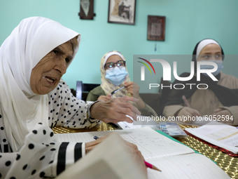 Palestinian teacher Ekram el-astal, 80, teaches her neighbours' students an Maths language lesson as schools are shut due to the coronavirus...