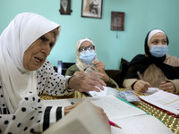 Palestinian teacher Ekram el-astal, 80, teaches her neighbours' students an Maths language lesson as schools are shut due to the coronavirus...