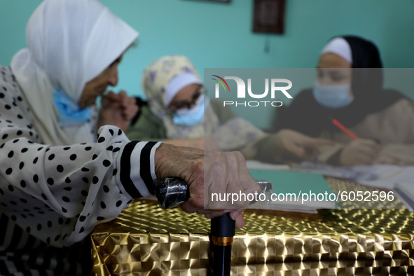 Palestinian teacher Ekram el-astal, 80, teaches her neighbours' students an Maths language lesson as schools are shut due to the coronavirus...