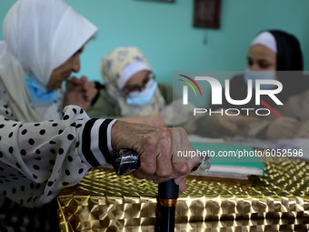 Palestinian teacher Ekram el-astal, 80, teaches her neighbours' students an Maths language lesson as schools are shut due to the coronavirus...