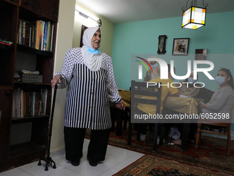 Palestinian teacher Ekram el-astal, 80, teaches her neighbours' students an Maths language lesson as schools are shut due to the coronavirus...