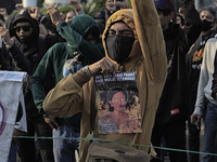 A Indonesian student holds a poster, the speaker of the Indonesian Parliament, during a demonstration against a new Indonesian labour law pa...