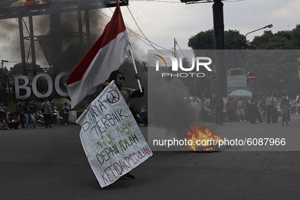 A Indonesian student shout a slogan during a demonstration against a new Indonesian labour law passed last week, in Bogor, West Java, Octobe...