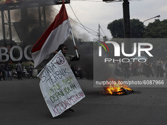 A Indonesian student shout a slogan during a demonstration against a new Indonesian labour law passed last week, in Bogor, West Java, Octobe...