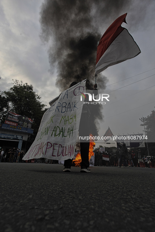 A Indonesian student shout a slogan during a demonstration against a new Indonesian labour law passed last week, in Bogor, West Java, Octobe...