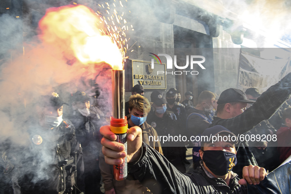 Veterans, activists and supporters of Ukraine's nationalist movements, light flares during a procession to mark the Defender of Ukraine Day...