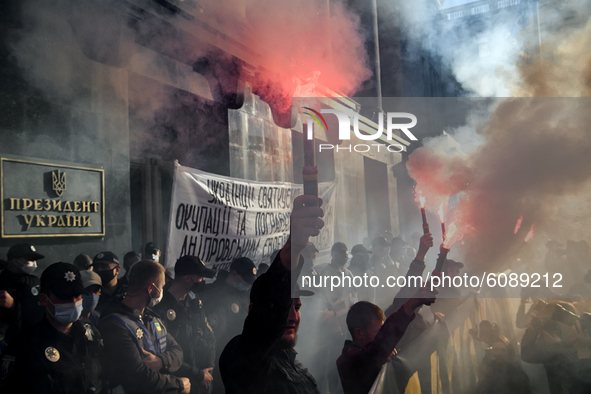 Veterans, activists and supporters of Ukraine's nationalist movements, light flares during a procession to mark the Defender of Ukraine Day...