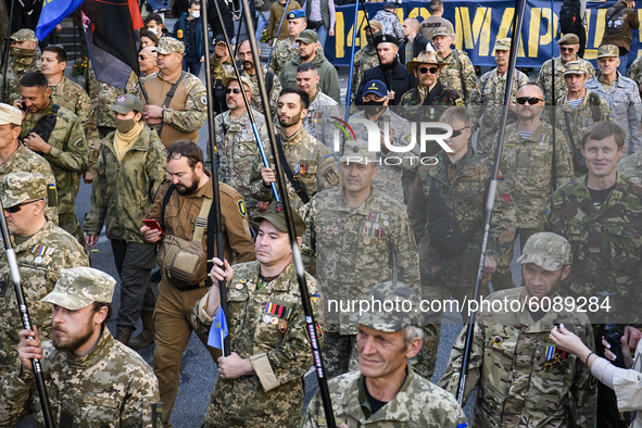 Veterans, activists and supporters of Ukraine's nationalist movements take part in a procession to mark the Defender of Ukraine Day and the...