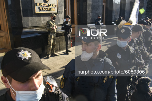 Policemen wearing protective masks as a preventive measure against the coronavirus COVID-19 stand guard outside the President Volodymyr Zele...