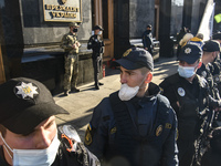 Policemen wearing protective masks as a preventive measure against the coronavirus COVID-19 stand guard outside the President Volodymyr Zele...