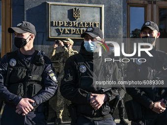 Policemen wearing protective masks as a preventive measure against the coronavirus COVID-19 stand guard outside the President Volodymyr Zele...