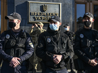 Policemen wearing protective masks as a preventive measure against the coronavirus COVID-19 stand guard outside the President Volodymyr Zele...