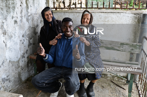 Rhys Gordon is entertaining two of his elderly neighbours in the village of Kostur, Bulgaria on May 02, 2015 