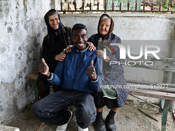 Rhys Gordon is entertaining two of his elderly neighbours in the village of Kostur, Bulgaria on May 02, 2015 (