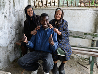 Rhys Gordon is entertaining two of his elderly neighbours in the village of Kostur, Bulgaria on May 02, 2015 (