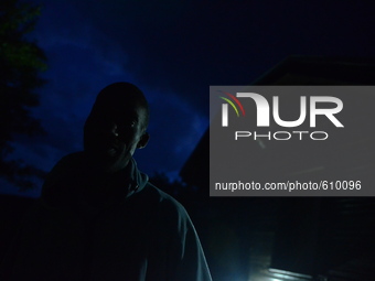 Narrall Gordon standing in front of his house in the night in the village of Kostur, Bulgaria on May 12, 2015 (