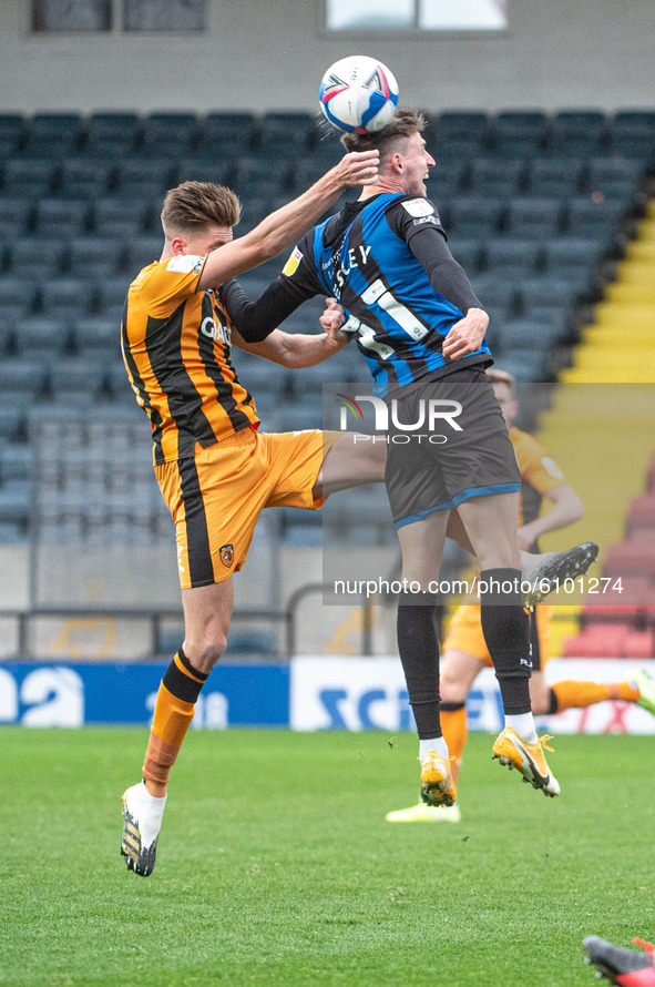 as Jake Beesley of Rochdale AFC goes for the ball, Richard Smallwood of Hull City FC pulls his shirt during the Sky Bet League 1 match betwe...