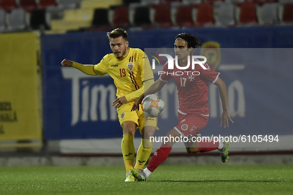 Denis Harut of Romania U21 in action against Liam McKay of Malta U21 during  the soccer match between Romania U21 and Malta U21 of the Quali...