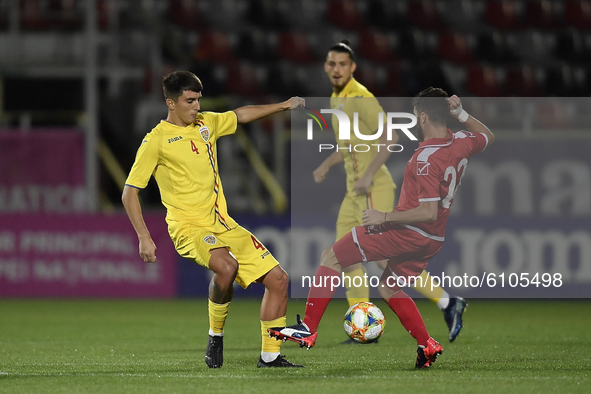 Stefan Vladoiu of Romania U21 in action against James Scicluna  of Malta U21 during  the soccer match between Romania U21 and Malta U21 of t...