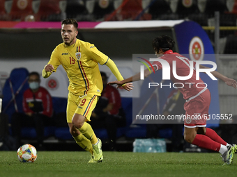 Denis Harut of Romania U21 in action against Liam McKay of Malta U21 during the soccer match between Romania U21 and Malta U21 of the Qualif...