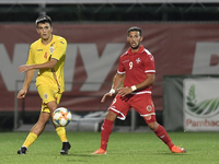 Stefan Vladoiu of Romania U21 in action against Omar Elouni of Malta U21 during the soccer match between Romania U21 and Malta U21 of the Qu...