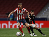 Marcos Llorente of Atletico Madrid and Lucas Hernandez of Bayern compete for the ball during the UEFA Champions League Group A stage match b...