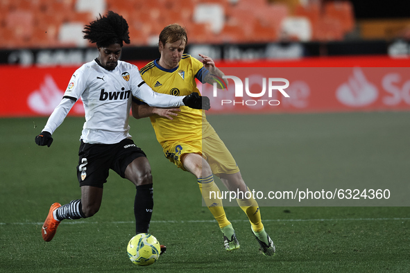Alex Fernandez of Cadiz and Thierry Correia of Valencia  compete for the ball during the La Liga Santander match between Valencia CF and Cad...