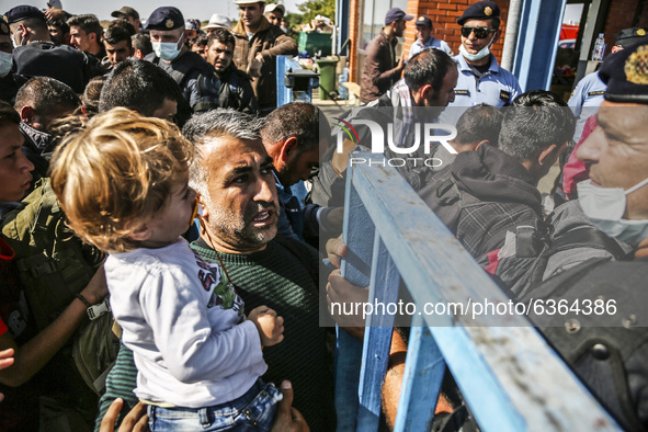 Migrants are waiting to enter to the transfer camp in Opatovac near border crossing point between Serbia and Croatia. Opatovac, Croatia. Sep...