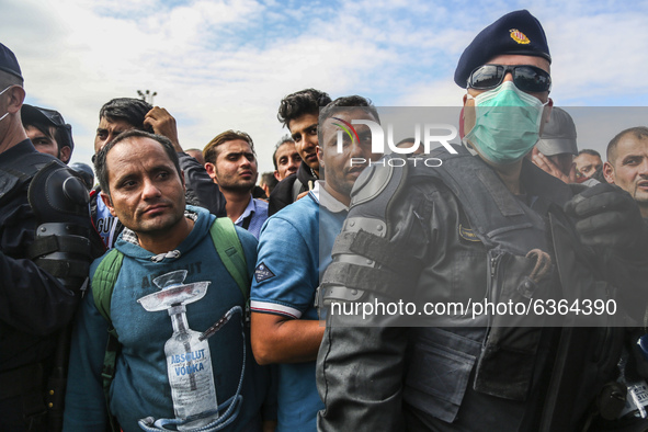 Migrants are waiting to enter to the transfer camp in Opatovac near border crossing point between Serbia and Croatia. Opatovac, Croatia. Sep...