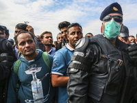 Migrants are waiting to enter to the transfer camp in Opatovac near border crossing point between Serbia and Croatia. Opatovac, Croatia. Sep...