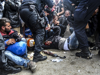 A migrant collapses while waiting to enter to the transfer camp in Opatovac near border crossing point between Serbia and Croatia. Opatovac,...