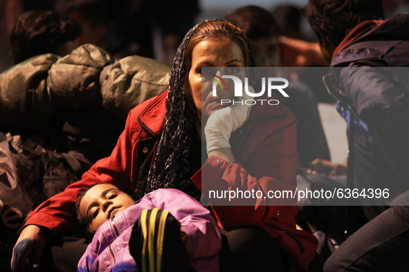 A  migrant mother waits with her child to enter to the temporary transfer camp in Opatovac near the border crossing point between Serbia and...