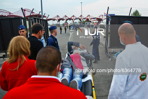 A pregnant refugee woman is being assisted while arriving at the Hungary-Croatia border point in Baranjsko Petrovo Selo, Croatia, on Septemb...