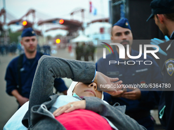 A pregnant refugee woman is being assisted while arriving at the Hungary-Croatia border point in Baranjsko Petrovo Selo, Croatia, on Septemb...