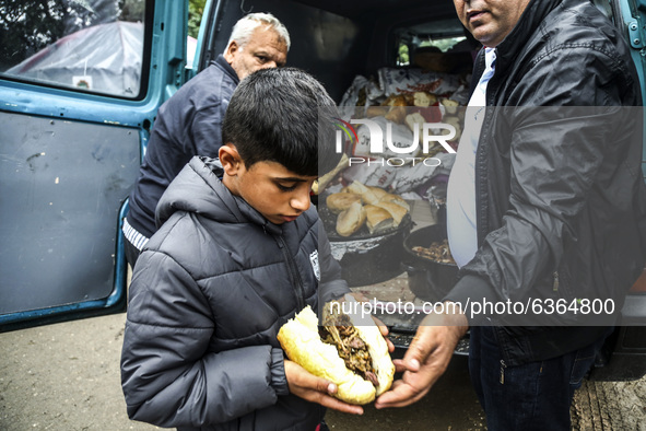 A refugee boy gets a meal at the Serbia-Croatia border, between Berkasovo and Bapska on September 26, 2015. A record number of refugees from...