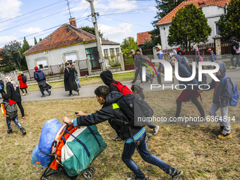 Refugees walk to the Hungarian-Austrian border between Hegyeshalom and Nickelsdorf, after they arrived by train to Hegyeshalom, Hungary on 2...