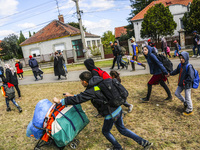 Refugees walk to the Hungarian-Austrian border between Hegyeshalom and Nickelsdorf, after they arrived by train to Hegyeshalom, Hungary on 2...