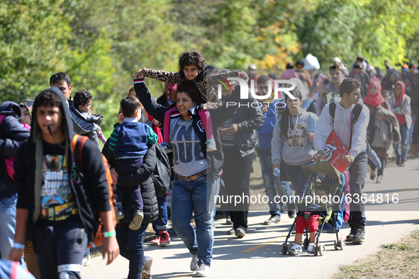 Hundreds of refugees walk to the Hungarian-Austrian border between Hegyeshalom and Nickelsdorf, after they arrived by train to Hegyeshalom,...