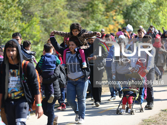 Hundreds of refugees walk to the Hungarian-Austrian border between Hegyeshalom and Nickelsdorf, after they arrived by train to Hegyeshalom,...